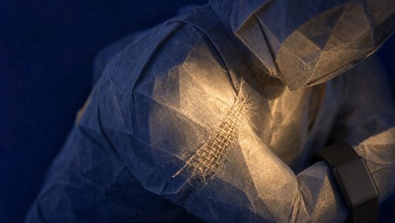 Torn paper fibers reweaving in warm night light